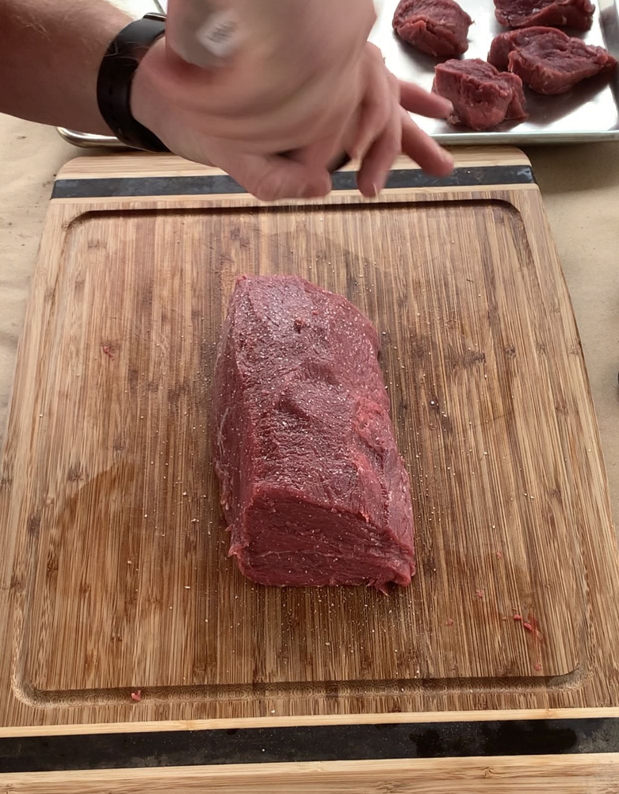 sprinkling beef tenderloin with salt
